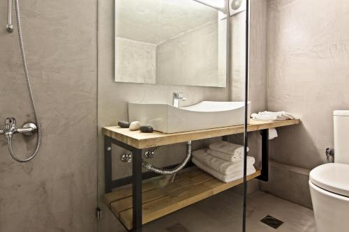 a bathroom with a sink and a shower at Central Apartment in Athens