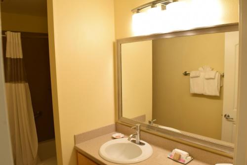 a bathroom with a sink and a mirror at Multi Resorts at Aquamarine Villas in Oceanside