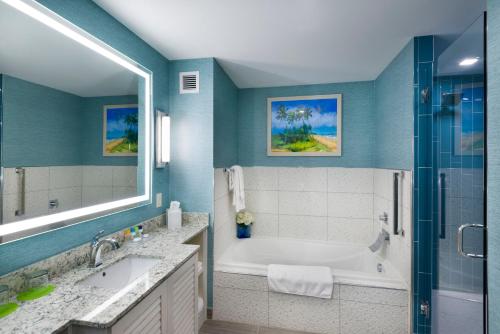 a bathroom with a tub and a sink and a shower at Margaritaville Resort Gatlinburg in Gatlinburg