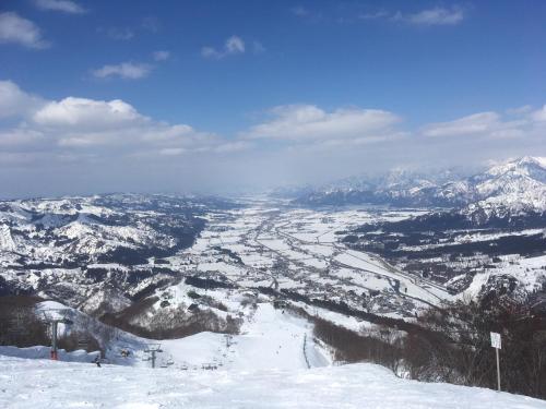 a view from the top of a snow covered mountain at Maruyama Onsen Kojyokan in Minami Uonuma