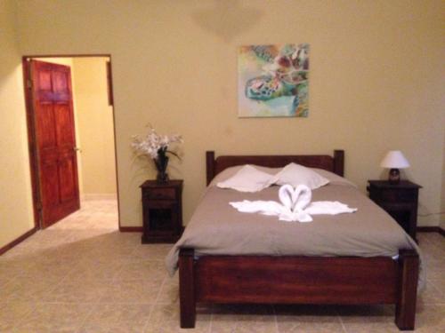 a bedroom with a bed with a butterfly on it at Hotel Jinetes de Osa in Drake