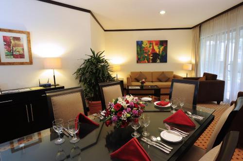 a dining room with a table with wine glasses at Hotel Borobudur Jakarta in Jakarta
