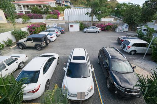 a group of cars parked in a parking lot at La Jamaca - An Island Vibe Hotel in La Parguera