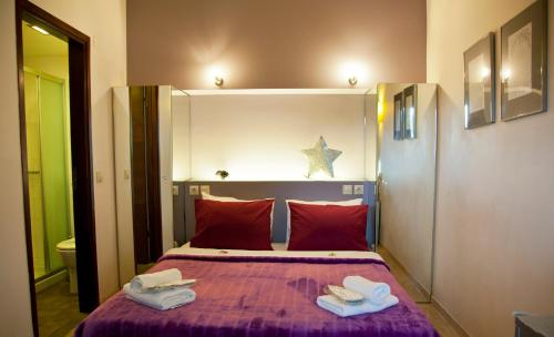 a bedroom with a bed with towels on it at Grimani Pension in Nafplio