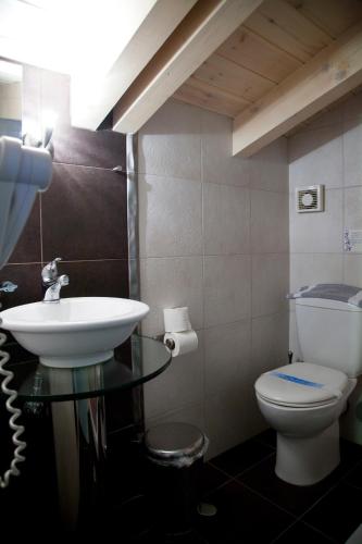 a bathroom with a sink and a toilet at Grimani Pension in Nafplio