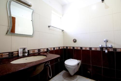 a bathroom with a toilet and a sink and a mirror at Hotel Imperial Classic in Hyderabad