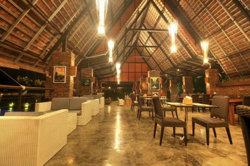 a dining room with tables and chairs in a building at Shankara Borobudur in Borobudur