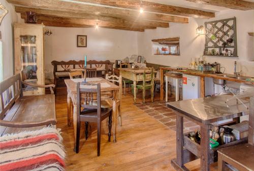 a dining room with wooden tables and chairs at Dominic Boutique - Gardener's Cottage in Cloaşterf