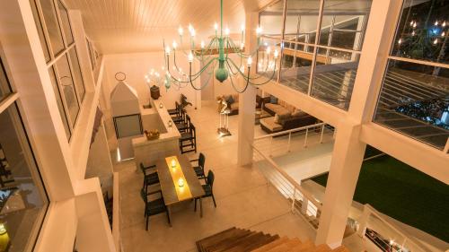 a room with a chandelier and a table and chairs at 18 Faces with free drop off to Galle Fort by TukTuk in Galle