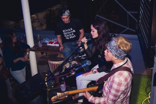 a group of people playing instruments at a party at Z Hostel in Manila