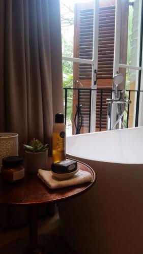 a bottle of mouthwash sitting on a table next to a window at Amberhall Guesthouse in Johannesburg
