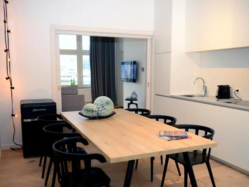 a kitchen and a table with chairs in a room at M-Maastricht in Maastricht