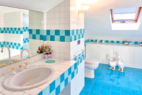 a blue and white bathroom with a sink and a toilet at Villa HELVEZIA in Levanto