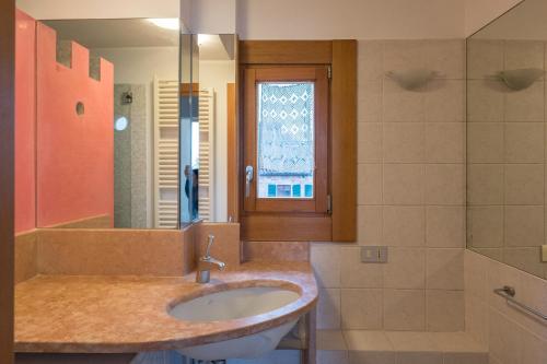 a bathroom with a sink and a mirror at Cà Nicoletto by Venicevillas, Lido in Venice-Lido