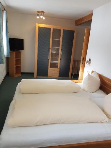 a group of three beds in a room at Gasthof Schützenwirt in Steinach am Brenner