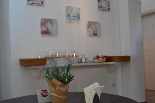 a table with a vase of flowers in a kitchen at Etesia in Olbia