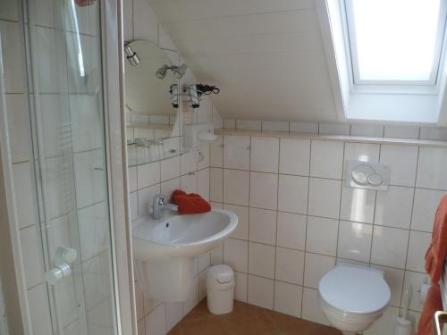 a bathroom with a sink and a toilet and a shower at Landgasthof Zur scharfen Ecke in Hildesheim