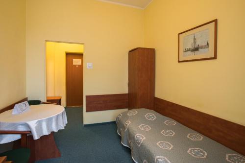 Postel nebo postele na pokoji v ubytování Hotel Kapitan