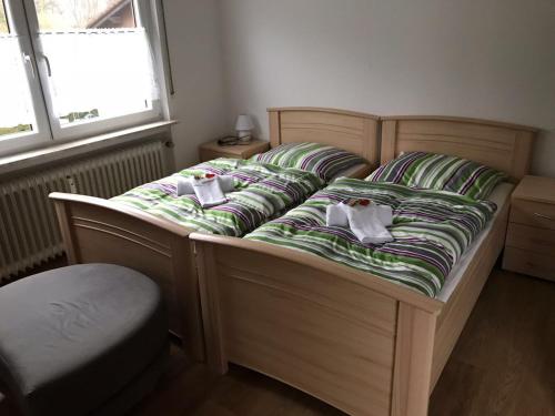 a bed with two pillows on it in a bedroom at Frankenstube in Eichelsdorf