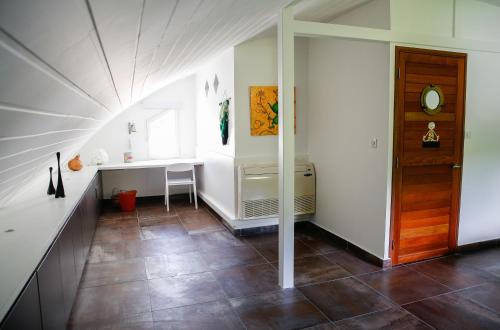 an attic room with a door and a tile floor at Nolitha in Manapany-les Bains
