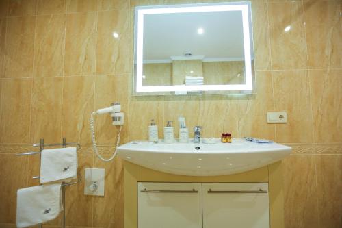 a bathroom with a sink and a mirror at Home Hotel in Bukovel