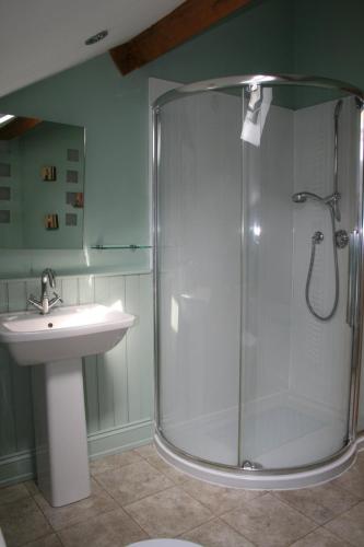 a bathroom with a shower and a sink at The Byre in Keswick