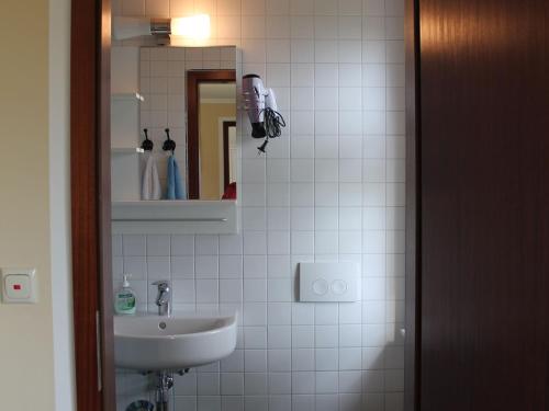 a bathroom with a sink and a mirror at Gorgeous Bungalow in Pepelow near Sea Beach in Pepelow