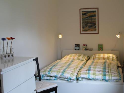 two pillows sitting on a bed in a room at Gorgeous Bungalow in Pepelow near Sea Beach in Pepelow