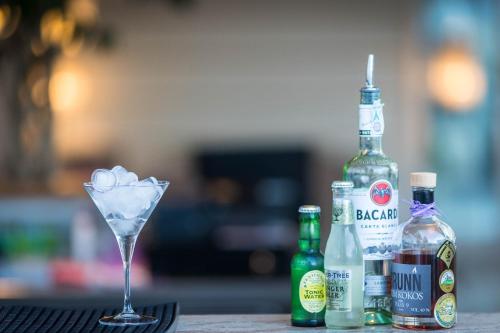a martini glass and bottles of alcohol on a table at Hotel Weingarten in Appiano sulla Strada del Vino