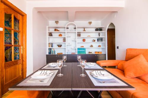 a dining room with a table and a couch at Piso primera línea de playa in Málaga