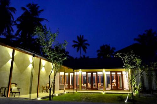 a home at night with the lights on at Kethaka Aga in Tissamaharama