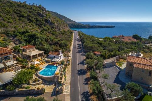 an aerial view of a house with a swimming pool and a road at Palataki in Kardamyli