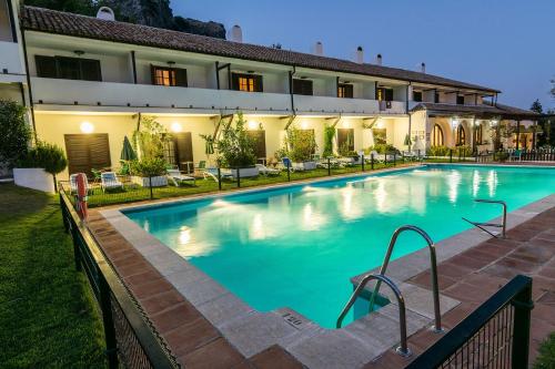 a large swimming pool in front of a building at Villa Turística de Grazalema in Grazalema