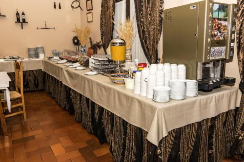 a long table with white plates on it at Villa Turística de Grazalema in Grazalema