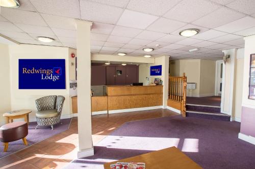 a waiting room in a hospital with a reception desk and a lobby at Redwings Lodge Solihull in Solihull
