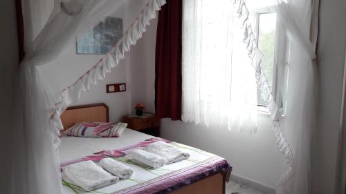 a bedroom with a bed with towels on it at Akay Hotel in Patara