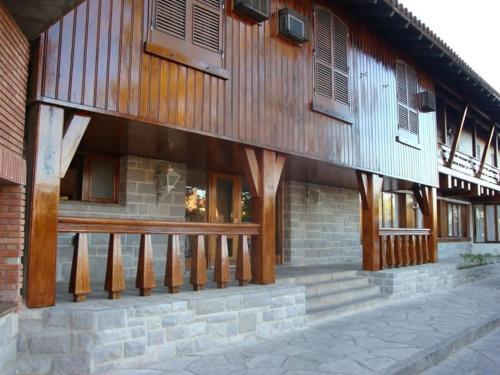 a wooden building with a porch and a balcony at Hotel Dos Venados in San Luis