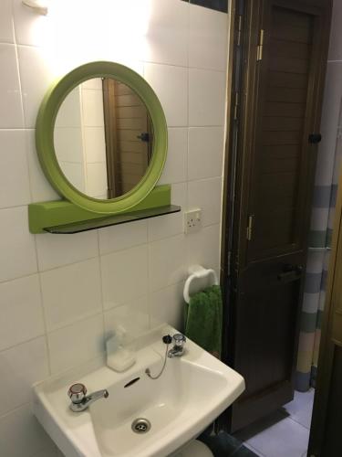 a bathroom with a sink and a mirror at Cosy Studio in Marsalforn