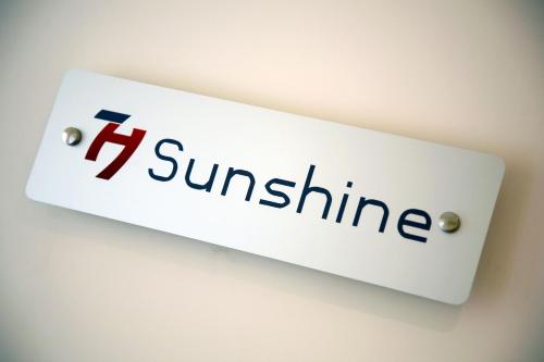 a sign for the company sunline on a wall at Seven Hostel & Rooms in Sant'Agnello