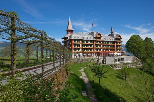 a large building with towers on top of a hill at Jugendstilhotel Paxmontana in Sachseln