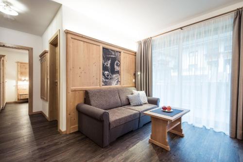a living room with a couch and a table at Residence Panorama Pfelders in Pfelders
