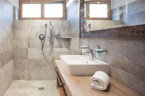 a bathroom with a sink and a shower at Residence Panorama Pfelders in Pfelders