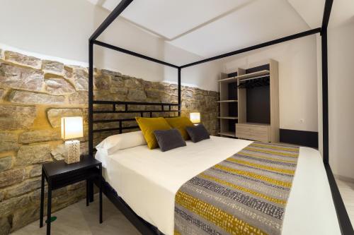 En eller flere senge i et værelse på Hotel Onyarbi