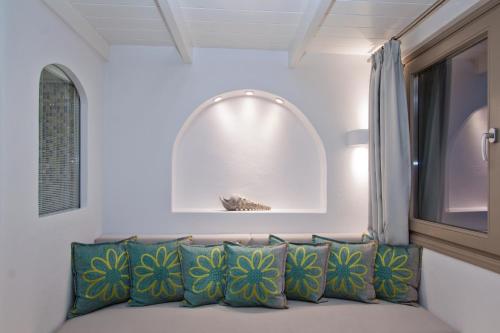 a couch in a room with a window at Nemesis in Fira