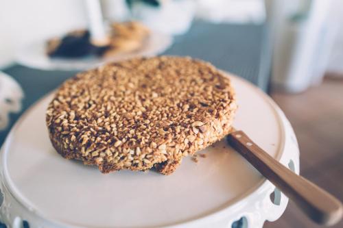 a piece of bread on a white plate with a spatula at Casa Baricalino in Novello