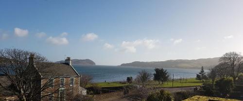 a house with a view of a body of water at Ardshiel Hotel in Campbeltown