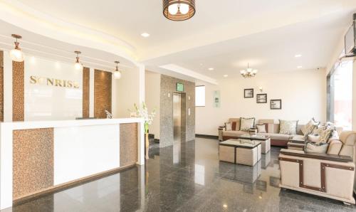 a lobby with couches and tables in a building at Treebo Trend Sunrise IG Road in Chikmagalūr