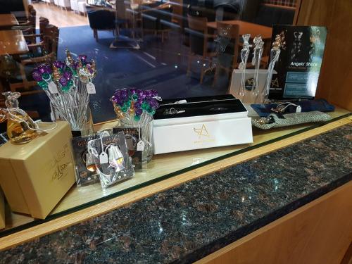 a counter with flowers and a box on it at Ardshiel Hotel in Campbeltown