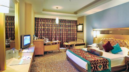 a hotel room with a bed and a desk at Royal Holiday Palace in Lara