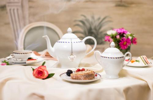 a table with two tea pots and a plate of food at Hotel Ponte Sisto in Rome